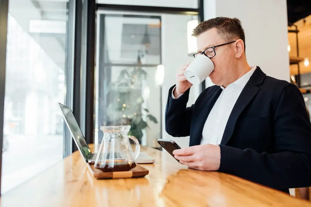 EASE IT Solutions client reviewing work over coffee